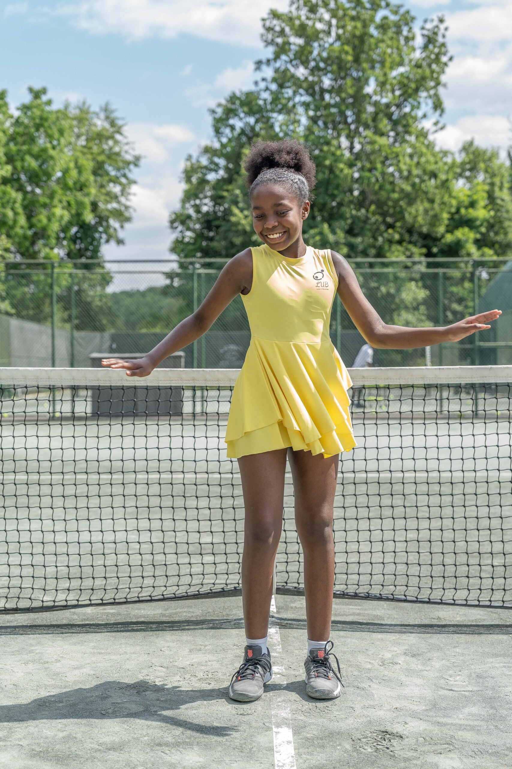 Love U Bunches tennis dress in yellow, featuring moisture-wicking technology to keep young athletes dry