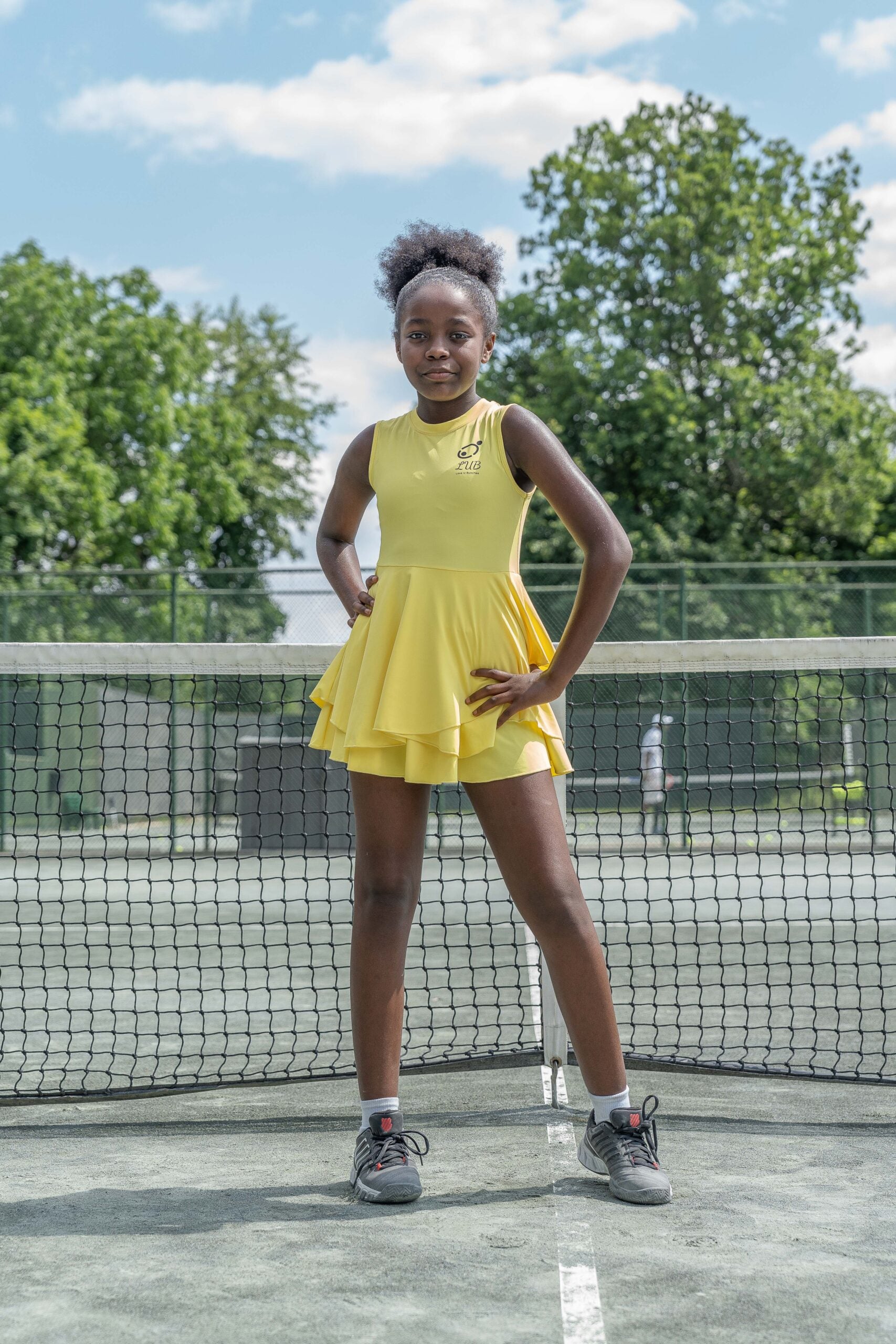 Love U Bunches tennis dress in yellow, featuring moisture-wicking technology to keep young athletes dry